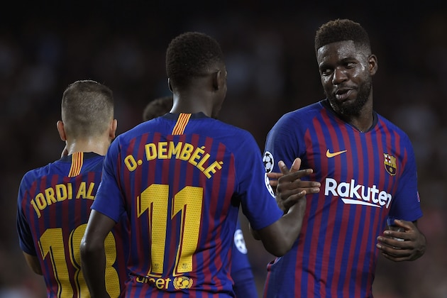 Barcelona's French forward Ousmane Dembele (C) celebrates after scoring with Barcelona's French defender Samuel Umtiti during the UEFA Champions' League group B football match FC Barcelona against PSV Eindhoven at the Camp Nou stadium in Barcelona on September 18, 2018. (Photo by LLUIS GENE / AFP)        (Photo credit should read LLUIS GENE/AFP via Getty Images)