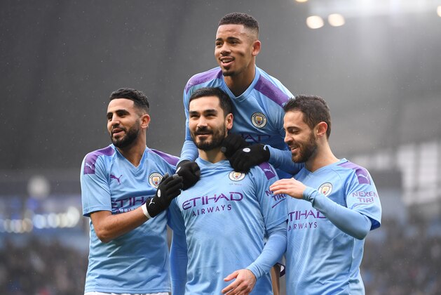 MANCHESTER, ENGLAND - JANUARY 26: Ilkay Gundogan (c) of Manchester City celebrates with Riyad Mahrez (l) , Gabriel Jesus and Bernardo Silva (r) after scoring a penalty during the FA Cup Fourth Round match between Manchester City and Fulham at Etihad Stadium on January 26, 2020 in Manchester, England. (Photo by Laurence Griffiths/Getty Images)