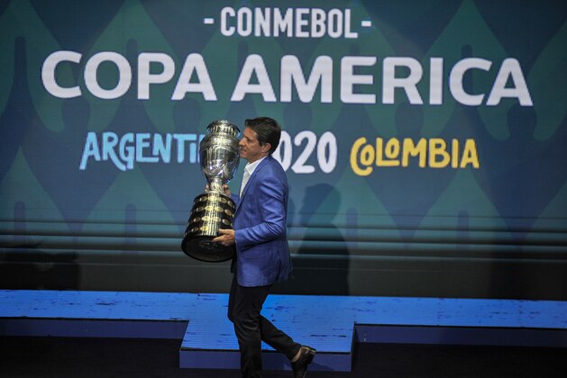 CARTAGENA, COLOMBIA - DECEMBER 03: Former Brazilian player Juninho Paulista holds the Copa America trophy during the draw for Copa America 2020 co-hosted by Argentina and Colombia at Centro de Convenciones de Cartagena de Indias on December 03, 2019 in Cartagena, Colombia.  (Photo by Guillermo Legaria/Getty Images)