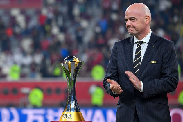 FIFA President Gianni Infantino stands with the winner's trophy during the 2019 FIFA Club World Cup Final football match between England's Liverpool and Brazil's Flamengo at the Khalifa International Stadium in the Qatari capital Doha on December 21, 2019. (Photo by Giuseppe CACACE / AFP) (Photo by GIUSEPPE CACACE/AFP via Getty Images)