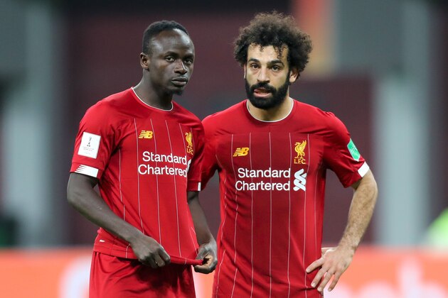 Liverpool's Senegalese striker Sadio Mane (L) speaks with Liverpool's Egyptian midfielder Mohamed Salah during the 2019 FIFA Club World Cup semi-final football match between Mexico's Monterrey and England's Liverpool at the Khalifa International Stadium in the Qatari capital Doha on December 18, 2019. (Photo by KARIM JAAFAR / AFP) (Photo by KARIM JAAFAR/AFP via Getty Images)