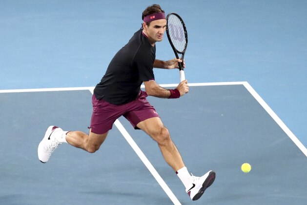 Switzerland's Roger Federer runs to make a return to Serbia's Novak Djokovic during their semifinal match at the Australian Open tennis championship in Melbourne, Australia, Thursday, Jan. 30, 2020. (AP Photo/Dita Alangkara)