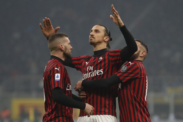 AC Milan's Zlatan Ibrahimovic, centre, celebrates with his teammates after he scored his side's second goal during the Serie A soccer match between Inter Milan and AC Milan at the San Siro Stadium, in Milan, Italy, Sunday, Feb. 9, 2020. (AP Photo/Antonio Calanni)