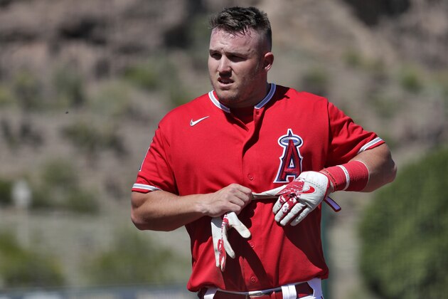 Los Angeles Angels' Mike Trout returns to the dugout at the end of the first inning of a spring training baseball game against the Seattle Mariners Wednesday, March 4, 2020, in Tempe, Ariz. (AP Photo/Matt York)