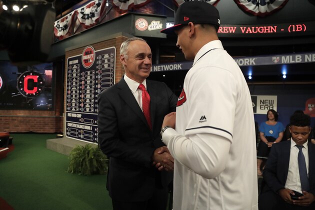 Major League Baseball commissioner Rob Manfred , left, talks to Daniel Espino, a right handed pitcher from the Georgia Premier Academy, in Statesboro, Ga., after he was selected No. 24 by the Cleveland Indians in the first round of the Major League Baseball draft, Monday, June 3, 2019, in Secaucus, N.J. (AP Photo/Julio Cortez)