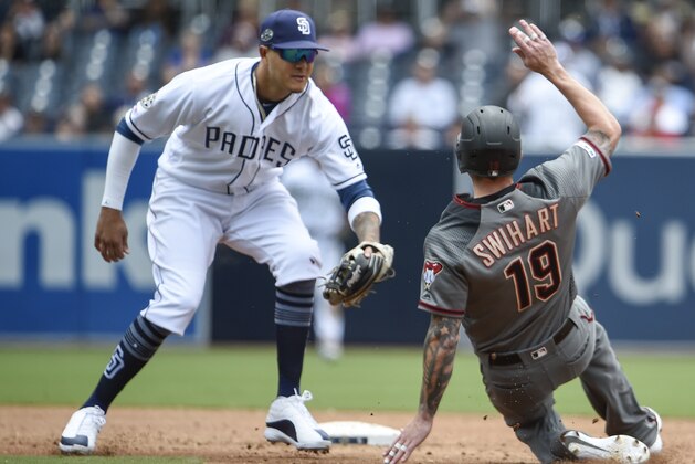 SAN DIEGO, CA - MAY 22: Blake Swihart #19 of the Arizona Diamondbacks is tagged out by Manny Machado #13 of the San Diego Padres as he turns a double  play during the third inning of a baseball game at Petco Park May 22, 2019 in San Diego, California.  (Photo by Denis Poroy/Getty Images)