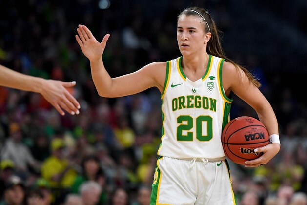 LAS VEGAS, NEVADA - MARCH 08:  Sabrina Ionescu #20 of the Oregon Ducks high-fives a teammate as they take on the Stanford Cardinal during the championship game of the Pac-12 Conference women's basketball tournament at the Mandalay Bay Events Center on March 8, 2020 in Las Vegas, Nevada. The Ducks defeated the Cardinal 89-56.  (Photo by Ethan Miller/Getty Images)