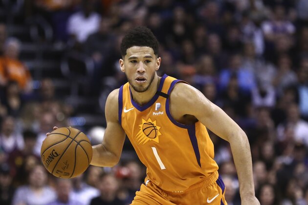 Phoenix Suns guard Devin Booker dribbles the ball against the Portland Trail Blazers during the second half of an NBA basketball game Friday, March 6, 2020, in Phoenix. The Suns defeated the Trail Blazers 127-117. (AP Photo/Ross D. Franklin)