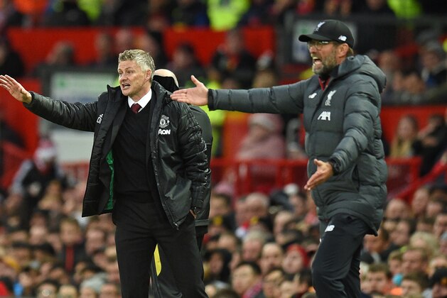 Manchester United's Norwegian manager Ole Gunnar Solskjaer (L) and Liverpool's German manager Jurgen Klopp (R) gesture on the touchline during the English Premier League football match between Manchester United and Liverpool at Old Trafford in Manchester, north west England, on October 20, 2019. (Photo by Oli SCARFF / AFP) / RESTRICTED TO EDITORIAL USE. No use with unauthorized audio, video, data, fixture lists, club/league logos or 'live' services. Online in-match use limited to 120 images. An additional 40 images may be used in extra time. No video emulation. Social media in-match use limited to 120 images. An additional 40 images may be used in extra time. No use in betting publications, games or single club/league/player publications. /  (Photo by OLI SCARFF/AFP via Getty Images)