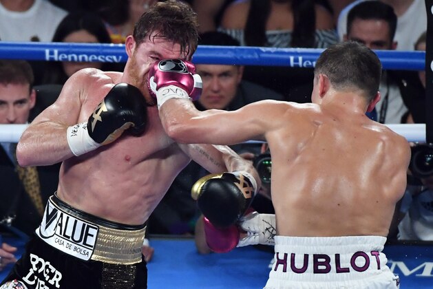 LAS VEGAS, NV - SEPTEMBER 15:  Gennady Golovkin (R) hits Canelo Alvarez in the third round of their WBC/WBA middleweight title fight at T-Mobile Arena on September 15, 2018 in Las Vegas, Nevada. Alvarez won by majority decision.  (Photo by Ethan Miller/Getty Images)