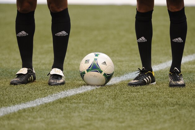VANCOUVER, CANADA - AUGUST 10: A generic view of an Adidas soccer ball as well as two soccer players sporting Adidas socks and shoes prior to an MLS match between the Vancouver Whitecaps and the San Jose Earthquakes at B.C. Place on August 10, 2013 in Vancouver, British Columbia, Canada. (Photo by Derek Leung/Getty Images)
