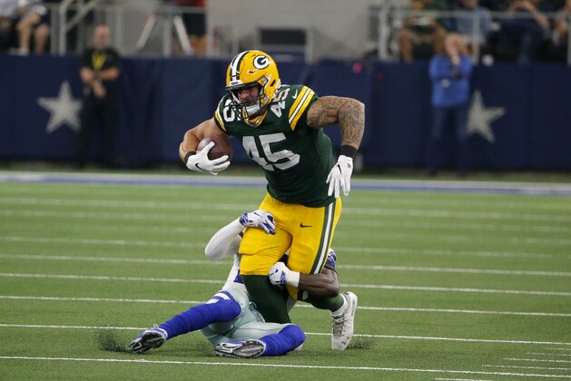 Green Bay Packers fullback Danny Vitale (45) fights for extra yardage after catching a pass as Dallas Cowboys free safety Xavier Woods (25) defends during an NFL football game in Arlington, Texas, Sunday, Oct. 6, 2019. (AP Photo/Michael Ainsworth)