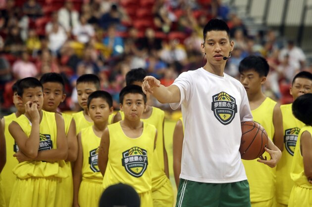 Former Toronto Raptors' Jeremy Lin, currently a free agent, talks to young Taiwanese players during a basketball clinic in Taipei, Taiwan, Saturday, July 27, 2019. Lin is in Taiwan to attend a charity event and basketball clinics for young athletes. (AP Photo/Chiang Ying-ying)