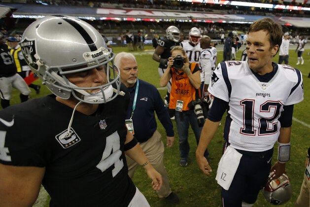 New England Patriots quarterback Tom Brady, right, talks with Oakland Raiders quarterback Derek Carr (4) after an NFL football game Sunday, Nov. 19, 2017, in Mexico City. (AP Photo/Eduardo Verdugo)