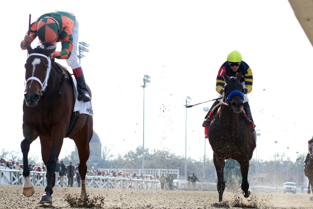 Jockey Gabriel Saez, left, reacts aboard Proud Spell (2) after winning the  $400,000 Fair Grounds Oaks horse race in front of favorite Indian Blessing (1)  with Garrett Gomez aboard, at the Fair Grounds race course, in New Orleans, Saturday, March 8, 2008.  (AP Photo/Lou Hodges, Jr.)