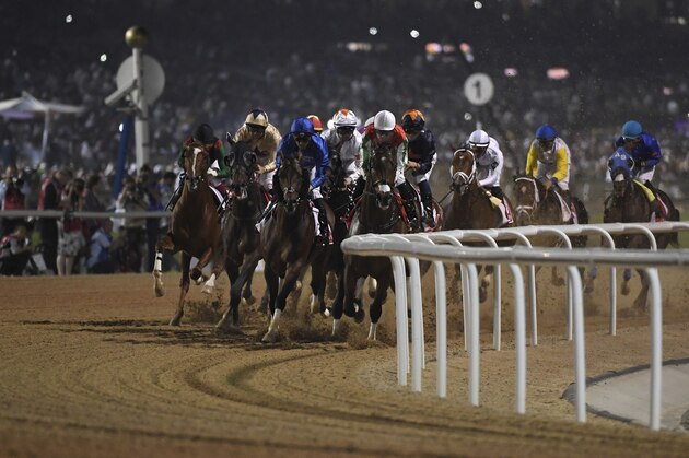 Horses gallop into the first turn of the $12 million Group 1 Dubai World Cup over 2000m with the eventual winner Thunder Snow with jockey Christophe Soumillon in the lead, Dubai, United Arab Emirates, Saturday, March 30, 2019. Thunder Snow is the only horse that won two Dubai World Cups in consecutive years. (AP Photo/Martin Dokoupil)