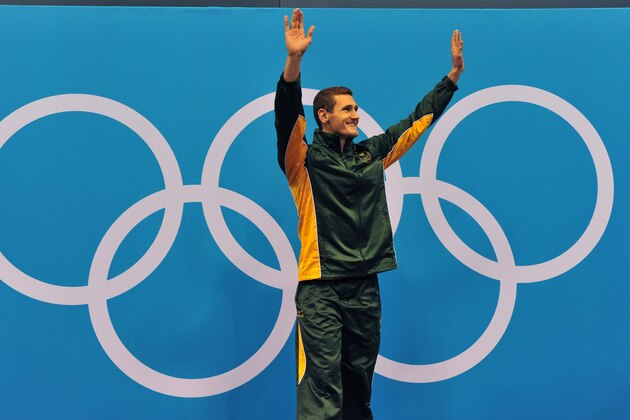 South Africa's gold medalist Cameron Van der Burgh poses on the podium after the men's 100m breaststroke swimming event at the London 2012 Olympic Games on July 29, 2012 in London.       AFP PHOTO / CHRISTOPHE SIMON        (Photo credit should read CHRISTOPHE SIMON/AFP/GettyImages)