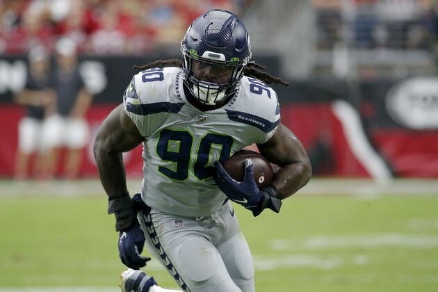 Seattle Seahawks outside linebacker Jadeveon Clowney (90) runs in an interception for a touchdown during the first half of an NFL football game against the Arizona Cardinals, Sunday, Sept. 29, 2019, in Glendale, Ariz. (AP Photo/Rick Scuteri)