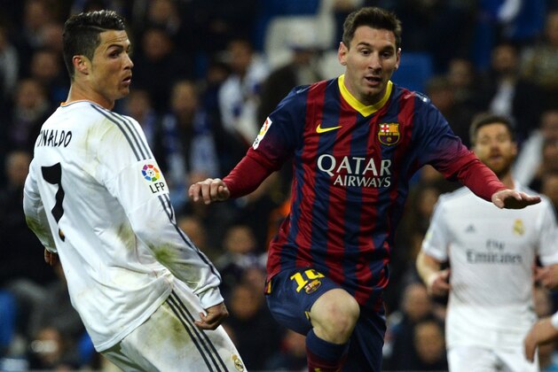 Barcelona's Argentinian forward Lionel Messi (R) vies with Real Madrid's Portuguese forward Cristiano Ronaldo during the Spanish league