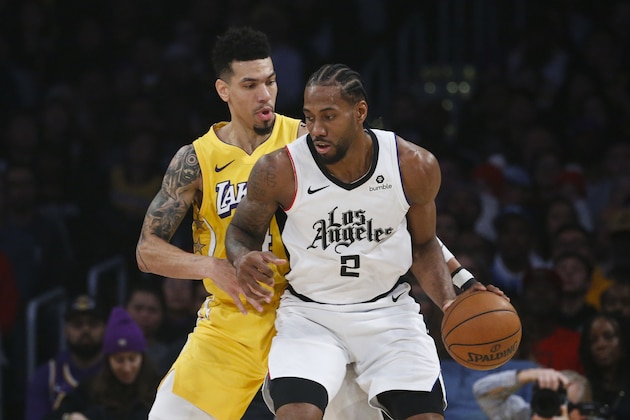 Los Angeles Clippers' Kawhi Leonard (2) is defended by Los Angeles Lakers' Danny Green (14) during an NBA basketball game between Los Angeles Lakers and Los Angeles Clippers, Wednesday, Dec. 25, 2019, in Los Angeles. The Clippers won 111-106. (AP Photo/Ringo H.W. Chiu)
