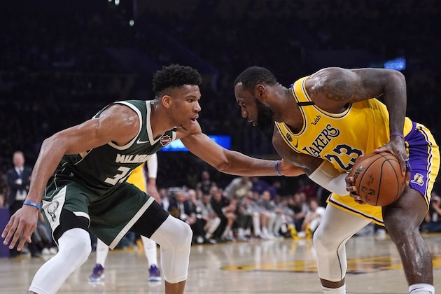 Los Angeles Lakers forward LeBron James, tries to get past Milwaukee Bucks forward Giannis Antetokounmpo during the second half of an NBA basketball game Friday, March 6, 2020, in Los Angeles. (AP Photo/Mark J. Terrill)