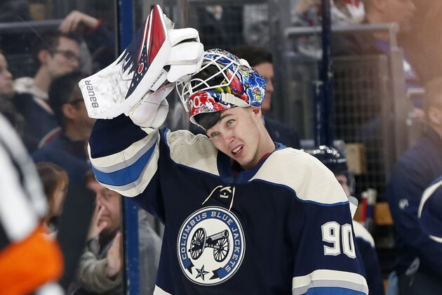 FILE - In this Wednesday, Jan. 22, 2020, file photo, Columbus Blue Jackets' Elvis Merzlikins, of Latvia, puts his facemask on after a time out in the third period of an NHL hockey game against the Winnipeg Jets in Columbus, Ohio. The rookie goaltender from Latvia has been terrific since stepping in for injured starter Joonas Korpisalo on Dec. 31.  (AP Photo/Jay LaPrete, File)