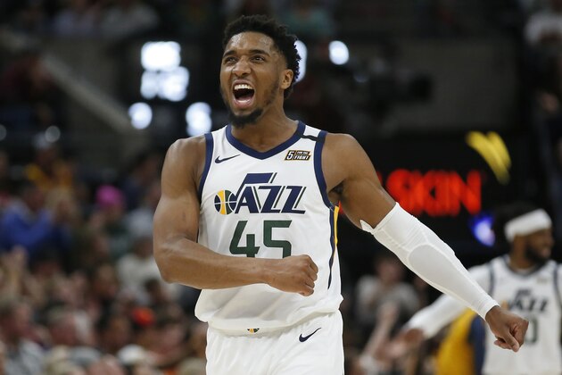 Utah Jazz guard Donovan Mitchell (45) reacts after a teammate scores against the Washington Wizards in the second half during an NBA basketball game Friday, Feb. 28, 2020, in Salt Lake City. (AP Photo/Rick Bowmer)