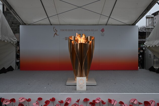 The Tokyo 2020 Olympic flame is displayed outside Fukushima railway station in Fukushima Prefecture on March 24, 2020. - The Olympic torch relay, due to begin on March 25 from a symbolic site in Fukushima, will proceed as scheduled but organisers said they would re-assess in the coming days given the The Tokyo 2020 Olympic flame is displayed outside Fukushima railway station in Fukushima Prefecture on March 24, 2020. - The Olympic torch relay, due to begin on March 25 from a symbolic site in Fukushima, will proceed as scheduled but organisers said they would re-assess in the coming days given the