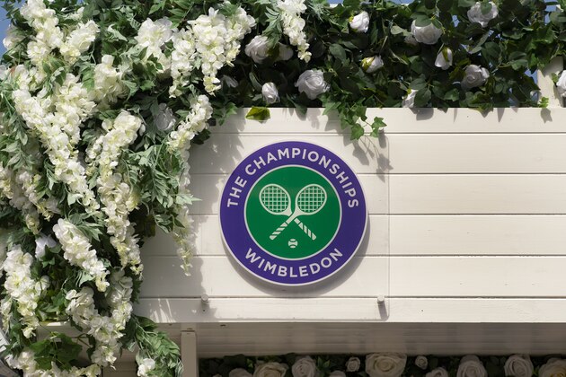 LONDON, ENGLAND - JULY 11: The Wimbledon logo surrounded by flowers during Day Ten of The Championships - Wimbledon 2019 at All England Lawn Tennis and Croquet Club on July 11, 2019 in London, England. (Photo by Visionhaus/Getty Images)