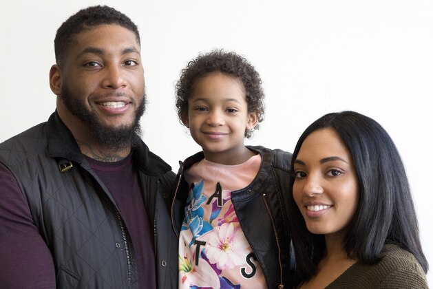 FILE - In this April 12, 2016, file photo, Devon Still and his fiancee, Asha Joyce, pose with their daughter, Leah, then 5, in New York. Leah was diagnosed in 2014 with cancer and became an inspiration to millions as her football-playing father shared details of her brave fight. She was given a prognosis of just over 50 percent to survive stage 4 neuroblastoma. Leah is now a healthy 8-year-old girl in third grade who lives in Houston. Devon Still has become an author, motivational speaker, and an inspiration--especially to strangers suffering like his family did. (AP Photo/Mark Lennihan, File)