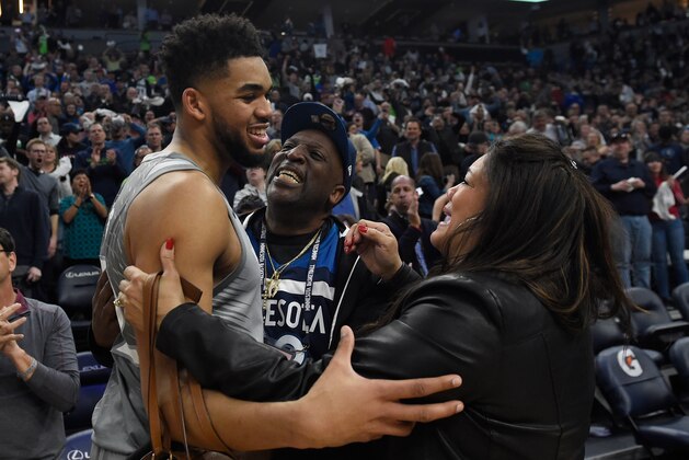 MINNEAPOLIS, MN - APRIL 11: Karl-Anthony Towns #32 of the Minnesota Timberwolves hugs his parents, Karl and Jackie Towns after winning the game against the Denver Nuggets on April 11, 2018 at the Target Center in Minneapolis, Minnesota. The Timberwolves defeated the Nuggets 112-106. NOTE TO USER: User expressly acknowledges and agrees that, by downloading and or using this Photograph, user is consenting to the terms and conditions of the Getty Images License Agreement. (Photo by Hannah Foslien/Getty Images)