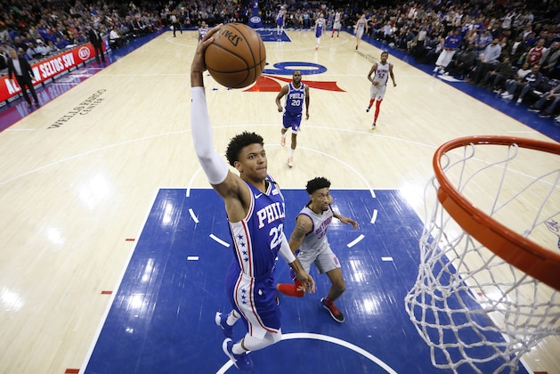 Philadelphia 76ers' Matisse Thybulle (22) goes up for a dunk past Detroit Pistons' Christian Wood (35) during the first half of an NBA basketball game, Wednesday, March 11, 2020, in Philadelphia. (AP Photo/Matt Slocum)