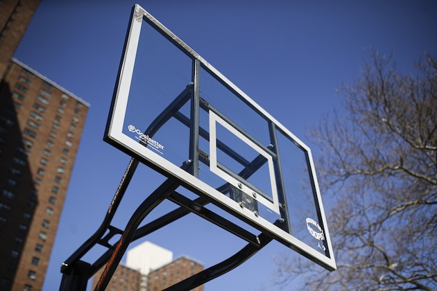 Basketball backboards stand without hoops after city officials had them removed to reduce gatherings at Holcombe Rucker Park, Thursday, March 26, 2020, in New York. The new coronavirus causes mild or moderate symptoms for most people, but for some, especially older adults and people with existing health problems, it can cause more severe illness or death. (AP Photo/John Minchillo)