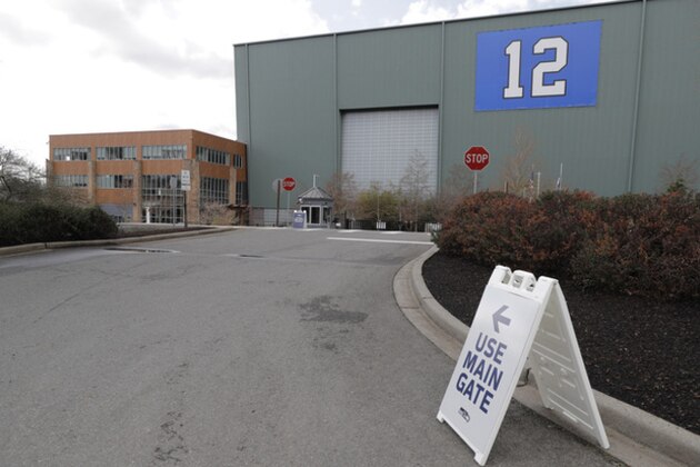 A sign points to the main gate of the Seattle Seahawks' NFL football practice facility and headquarters, Wednesday, March 25, 2020, in Renton, Wash. NFL Commissioner Roger Goodell has instructed all 32 teams to close their facilities to all but a select few employees by 6 p.m. Wednesday as a safeguard against the new coronavirus. The new coronavirus causes mild or moderate symptoms for most people, but for some, especially older adults and people with existing health problems, it can cause more severe illness or death. (AP Photo/Ted S. Warren)