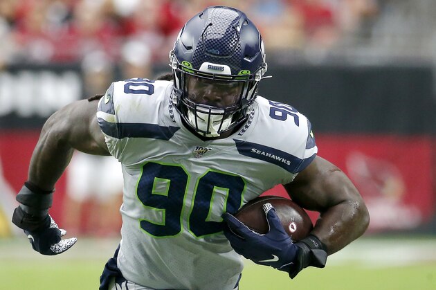 Seattle Seahawks outside linebacker Jadeveon Clowney (90) runs in an interception for a touchdown during the first half of an NFL football game against the Arizona Cardinals, Sunday, Sept. 29, 2019, in Glendale, Ariz. (AP Photo/Rick Scuteri)