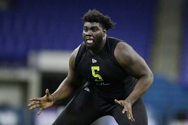Louisville offensive lineman Mekhi Becton runs a drill at the NFL football scouting combine in Indianapolis, Friday, Feb. 28, 2020. (AP Photo/Michael Conroy)