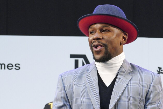 Floyd Mayweather Jr. smiles at the stage as he meets Japanese kickboxer Tenshin Nasukawa, during a ceremony at Saitama Super Arena in Saitama, north of Tokyo Sunday, Dec. 30, 2018. Mayweather is scheduled to fight in a three-round exhibition match in Japan on New Year's Eve. (AP Photo/Eugene Hoshiko)