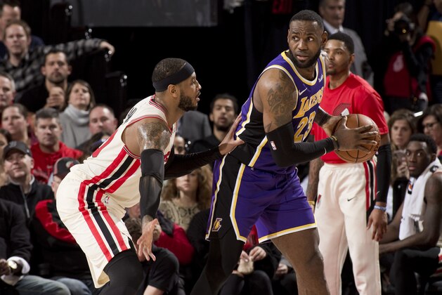 PORTLAND, OR - DECEMBER 28: LeBron James #23 of the Los Angeles Lakers dribbles the ball while guarded by Carmelo Anthony #00 of the Portland Trail Blazers on December 28, 2019 at the Moda Center Arena in Portland, Oregon. NOTE TO USER: User expressly acknowledges and agrees that, by downloading and or using this photograph, user is consenting to the terms and conditions of the Getty Images License Agreement. Mandatory Copyright Notice: Copyright 2019 NBAE (Photo by Cameron Browne/NBAE via Getty Images)