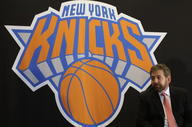 James Dolan, executive chairman of  Madison Square Garden, sits at a news conference next to the team logo where he introduced Phil Jackson as the new president of the New York Knicks, Tuesday, March 18, 2014 in New York. Jackson, who won two NBA titles as a player for the New York Knicks, also won 11 championships while coaching the Chicago Bulls and the Los Angeles Lakers. (AP Photo/Mark Lennihan)