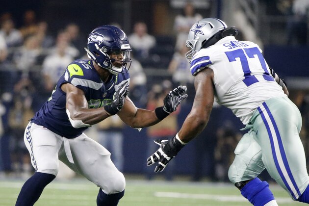 Seattle Seahawks defensive end Dion Jordan (95) defends against Dallas Cowboys offensive tackle Tyron Smith (77) during an NFC wild-card NFL football game in Arlington, Texas, Saturday, Jan. 5, 2019.(AP Photo/Michael Ainsworth)