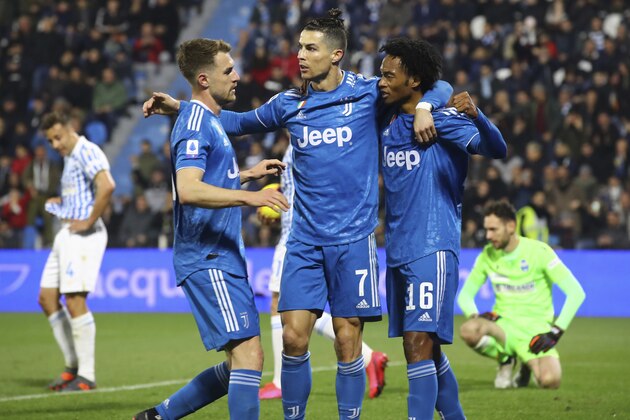 Juventus' Cristiano Ronaldo, center, celebrates with teammates Juan Cuadrado, right, and Aaron Ramsey after scoring his side's first goal, during an Italian Serie A soccer match between Spal and Juventus at the Paolo Mazza stadium in Ferrara, Italy, Saturday, Feb. 22, 2020. (Filippo Rubin/LaPresse via AP) Juventus' Cristiano Ronaldo, center, celebrates with teammates Juan Cuadrado, right, and Aaron Ramsey after scoring his side's first goal, during an Italian Serie A soccer match between Spal and Juventus at the Paolo Mazza stadium in Ferrara, Italy, Saturday, Feb. 22, 2020. (Filippo Rubin/LaPresse via AP)