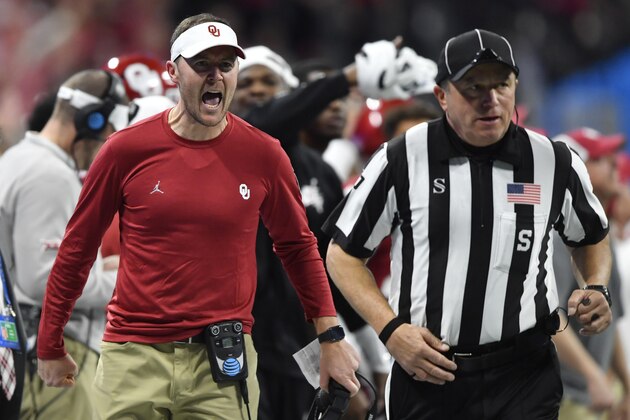 Oklahoma head coach Lincoln Riley speaks with an offical during the first half of the Peach Bowl NCAA semifinal college football playoff game against LSU, Saturday, Dec. 28, 2019, in Atlanta. (AP Photo/John Amis)