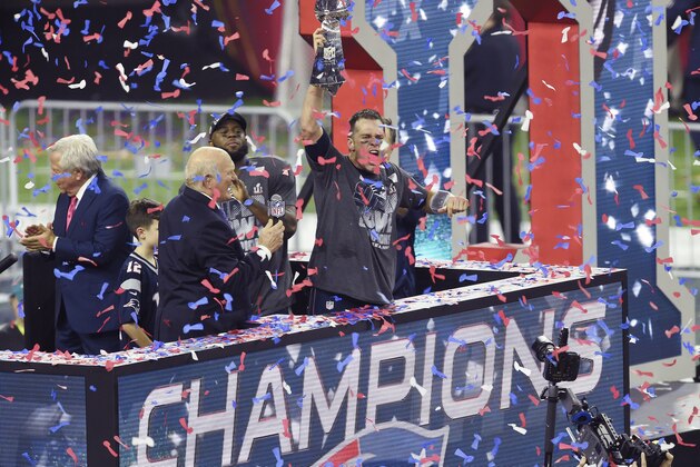 HOUSTON, TX - FEBRUARY 05: Tom Brady #12 of the New England Patriots raises the Vince Lombardi trophy after the Patriots defeat the Atlanta Falcons 34-28 in overtime of Super Bowl 51 at NRG Stadium on February 5, 2017 in Houston, Texas. (Photo by Focus on Sport/Getty Images)