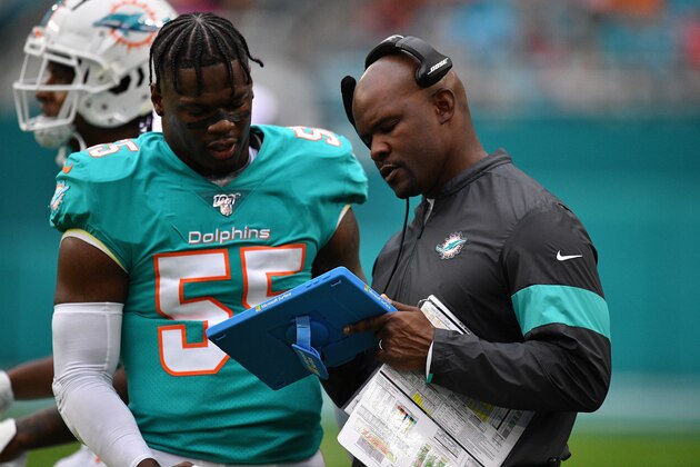 MIAMI, FLORIDA - DECEMBER 22: Jerome Baker #55 gets instructions from Head Coach Brian Flores of the Miami Dolphins during the game against the Cincinnati Bengals in the second quarter at Hard Rock Stadium on December 22, 2019 in Miami, Florida. (Photo by Mark Brown/Getty Images)