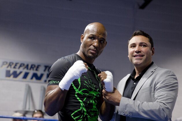In this Oct. 28, 2014 photo, Bernard Hopkins, left, poses for photographs with Oscar De La Hoya during a media workout in Philadelphia. Sergey Kovalev, of Russia, will fight Hopkins for his WBA Super World-IBF-WBO light heavyweight titles on Nov. 8, at Boardwalk Hall in Atlantic City, N.J. (AP Photo/Matt Rourke)