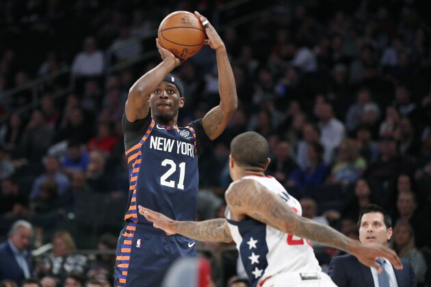 New York Knicks guard Damyean Dotson (21) goes up for a 3-point shot as Washington Wizards guard Gary Payton II (20) watches during the second half of an NBA basketball game in New York, Monday, Dec. 23, 2019. The Wizards won 121-115. (AP Photo/Kathy Willens) New York Knicks guard Damyean Dotson (21) goes up for a 3-point shot as Washington Wizards guard Gary Payton II (20) watches during the second half of an NBA basketball game in New York, Monday, Dec. 23, 2019. The Wizards won 121-115. (AP Photo/Kathy Willens)