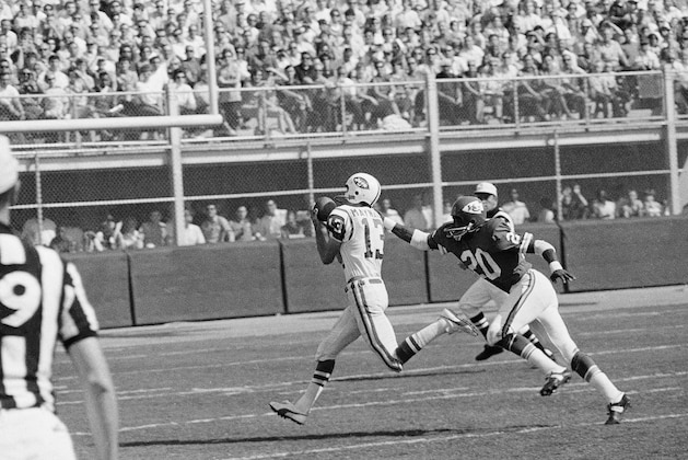 Don Maynard (13) of the New York Jets, gathers in a pass from Joe Namath, good for 56 yards, and scampers for the Jets first touchdown in the AFL game at Kansas City, Sept. 15, 1968. Reaching out for Maynard is Goldie Sellers (20). The Jets edged out the Chiefs, 20-19. (AP Photo/William P. Smith)
