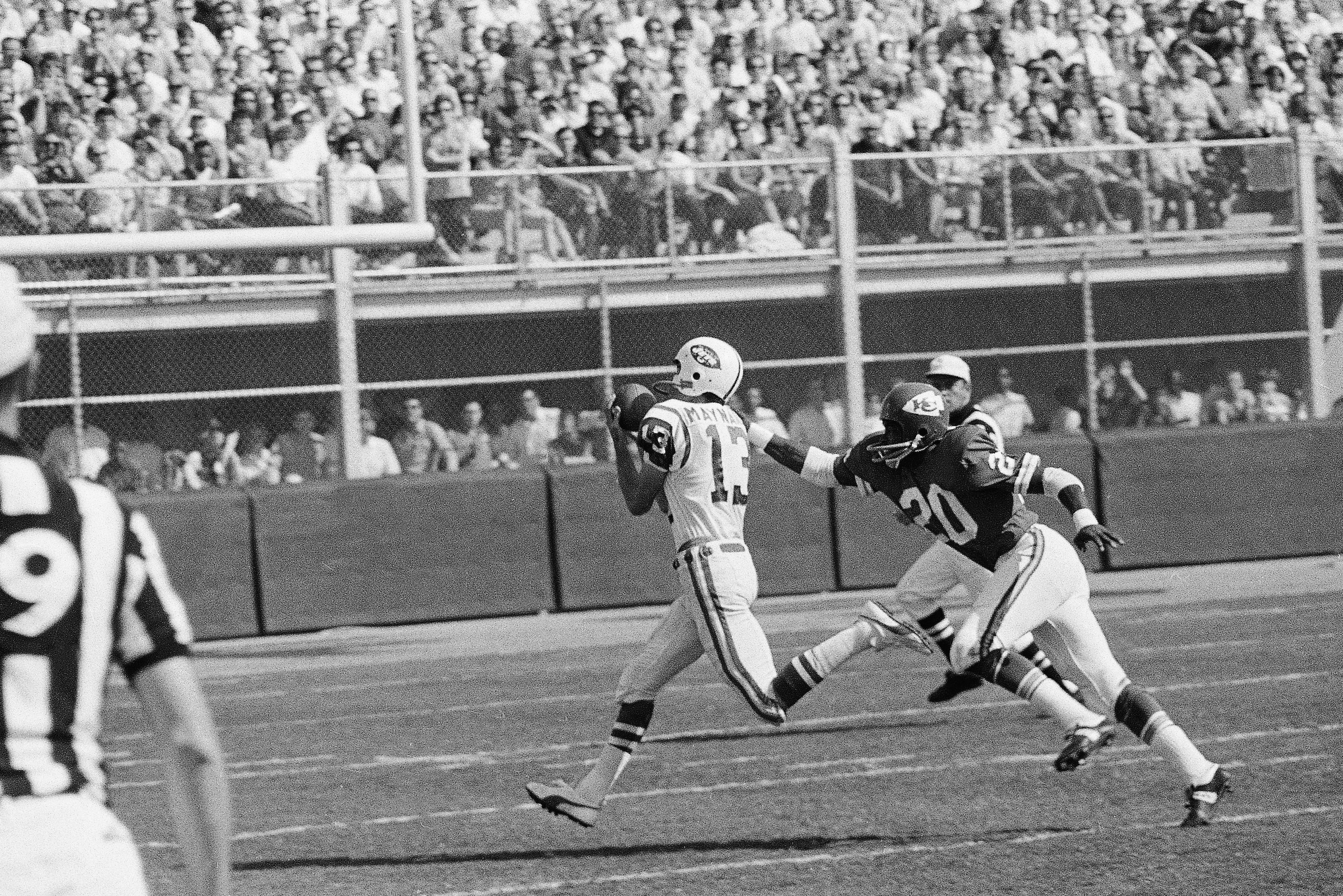 Don Maynard (13) of the New York Jets, gathers in a pass from Joe Namath, good for 56 yards, and scampers for the Jets first touchdown in the AFL game at Kansas City, Sept. 15, 1968. Reaching out for Maynard is Goldie Sellers (20). The Jets edged out the Chiefs, 20-19. (AP Photo/William P. Smith)