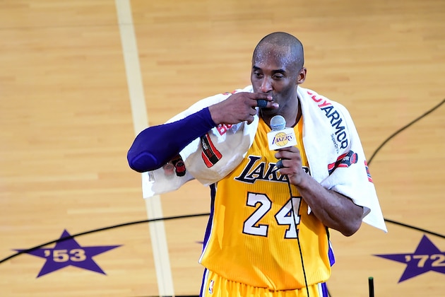 Kobe Bryant of the Los Angeles lakers gestures while addressing the fans following his final game as a Laker in their season-ending NBA western division matchup aginst the Utah Jazz in Los Angeles, California on April 13, 2016, where the Lakers defeated the Jazz 101-96. / AFP / FREDERIC J. BROWN        (Photo credit should read FREDERIC J. BROWN/AFP via Getty Images)