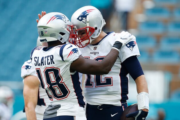 MIAMI, FL - DECEMBER 09:  Tom Brady #12 greets Matthew Slater #18 of the New England Patriots prior to their game against the Miami Dolphins at Hard Rock Stadium on December 9, 2018 in Miami, Florida.  (Photo by Michael Reaves/Getty Images)